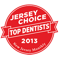 The image displays a red badge with white text featuring the words 'JERSEY CHOICE TOP DENTISTS 2013' at the top, followed by 'NEW JERSEY MONTHLY' below it and an emblem of a toothbrush and rays of light. The main part of the badge shows a red seal with white text stating 'TOP DENTISTS.' Below this, there is additional text that reads 'NJ MONTHLY 2013' and 'NEW JERSEY MONTHLY.' At the bottom of the badge, there's a small graphic of a toothbrush and rays of light. The background is white.