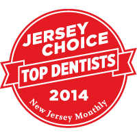 The image features a red circular stamp with white text, inside which there are two smaller rectangles containing additional text. The larger text reads 'JERSEY CHOICE TOP DENTISTS 2014' and below that, 'NEW JERSEY MONTHLY.' There is also an illustration of a toothbrush with bristles inside the top left corner of the stamp.