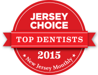 The image displays a red seal with white text indicating 'Jersey Choice Top Dentists 2015' along with a ribbon-like banner beneath it stating 'New Jersey Monthly.' The seal features a badge that reads 'Top Dentists 2015' and includes a graphic of a toothbrush.
