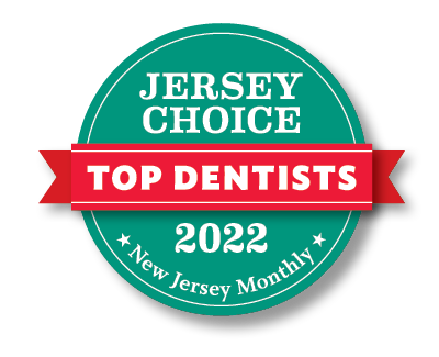 The image shows a badge with text that reads 'JERSEY CHOICE TOP DENTISTS 2022' with a red ribbon design, indicating recognition or an award for excellence in dentistry in New Jersey for the year 2022.