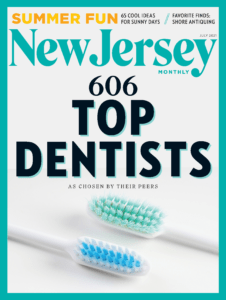 The image shows a magazine cover titled  New Jersey  with a headline reading  606 Top Dentists,  featuring two toothbrushes placed side by side on a surface, one of which has blue bristles and the other white.