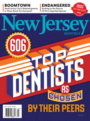 The image features a magazine cover with a headline reading  NEW JERSEY  and a subheadline stating  606 Top Dentists Chosen By Their Peers.  The cover also includes an illustration of a block with  Top Dentists  written on it, and the text  BOOMTOWN  is visible in the background.