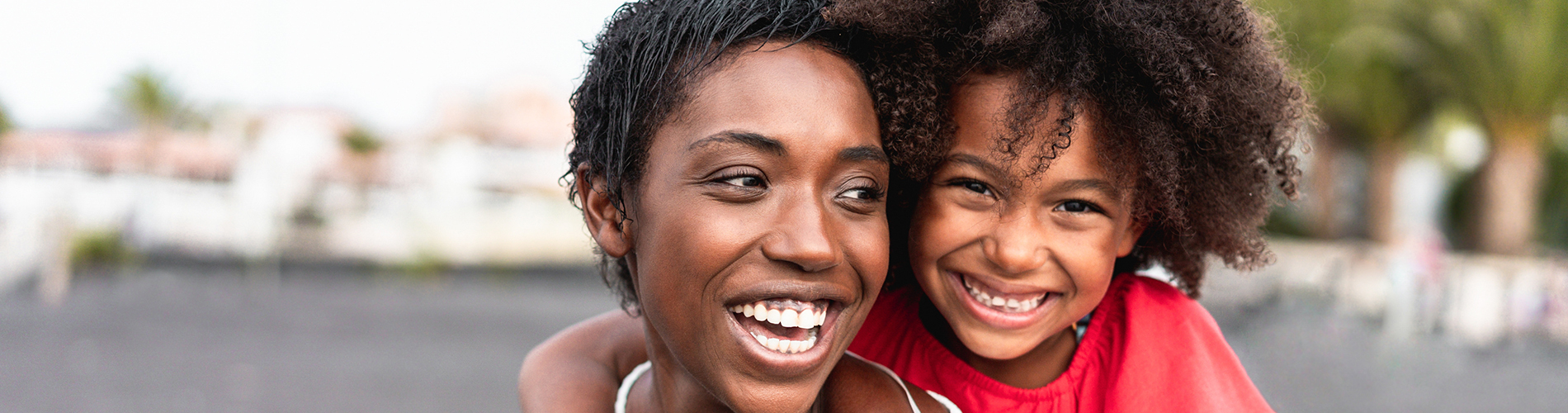 A well-lit reception area with a desk, computer monitor, and potted plant.
